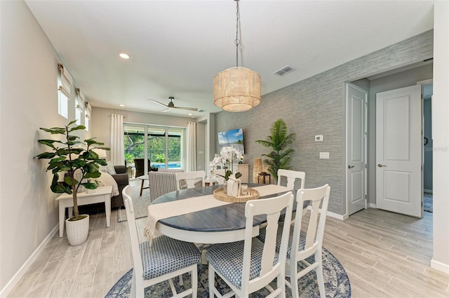 dining space featuring light wood-type flooring and ceiling fan