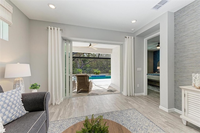 interior space featuring ceiling fan, light hardwood / wood-style floors, and plenty of natural light