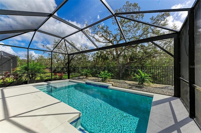 view of swimming pool featuring a patio area and glass enclosure