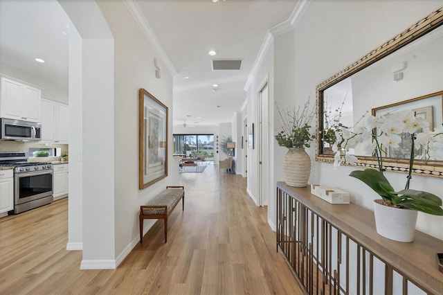 corridor featuring light hardwood / wood-style flooring and ornamental molding