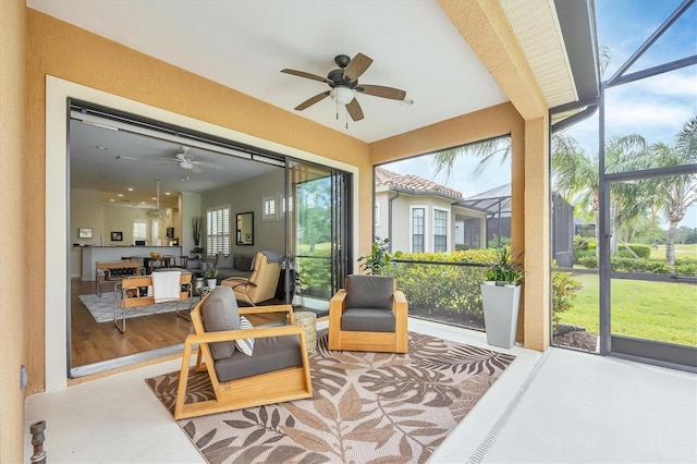 sunroom featuring ceiling fan