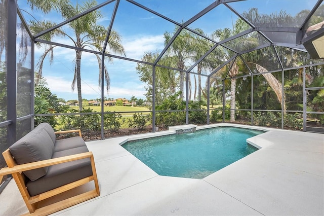 outdoor pool with glass enclosure and a patio