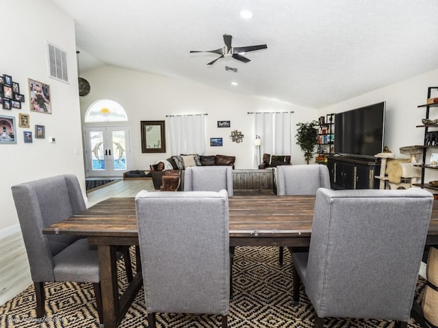 6317 Werner Ave, New Port Richey, FL 34652 - dining room with lofted ceiling, french doors, ceiling fan, wood finished floors, and recessed lighting