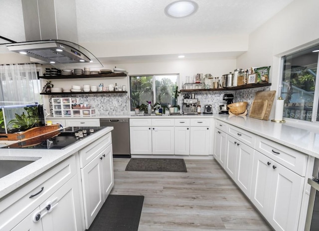 kitchen featuring backsplash, white cabinetry, stainless steel dishwasher, island range hood, and light hardwood / wood-style flooring
