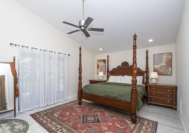 bedroom featuring lofted ceiling, light hardwood / wood-style flooring, and ceiling fan