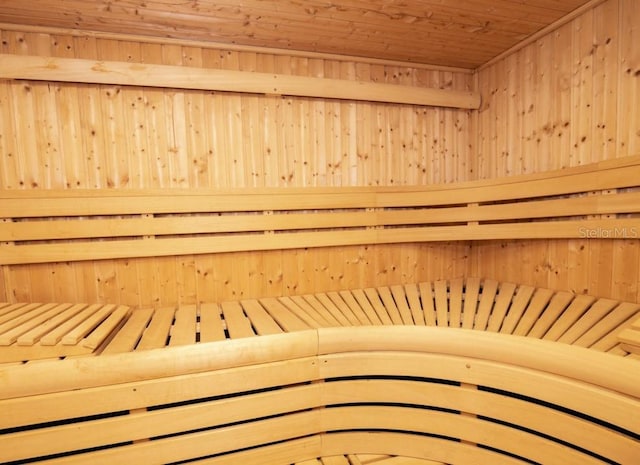 view of sauna / steam room featuring wood ceiling and wood walls