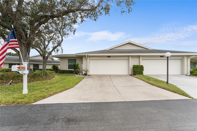 single story home featuring a garage, concrete driveway, a front lawn, and stucco siding