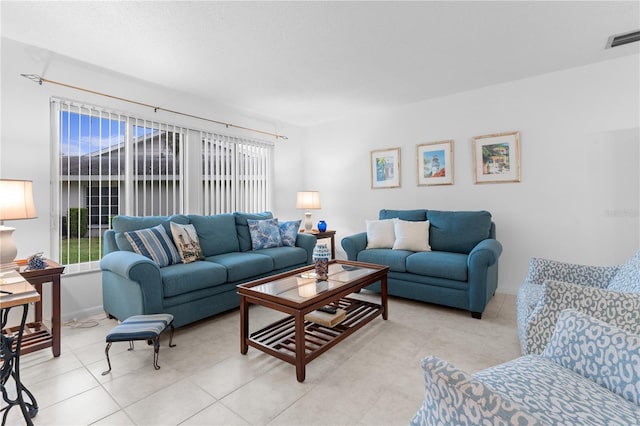 living area with light tile patterned floors and visible vents