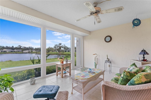 sunroom with a water view and a ceiling fan