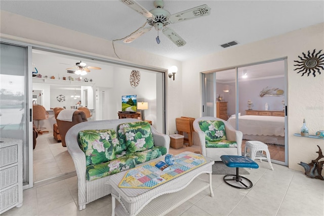 bedroom featuring visible vents, ceiling fan, and light tile patterned floors