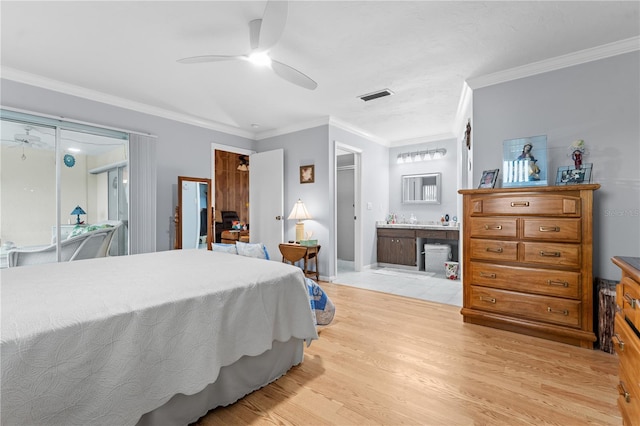 bedroom featuring a ceiling fan, baseboards, visible vents, light wood finished floors, and crown molding