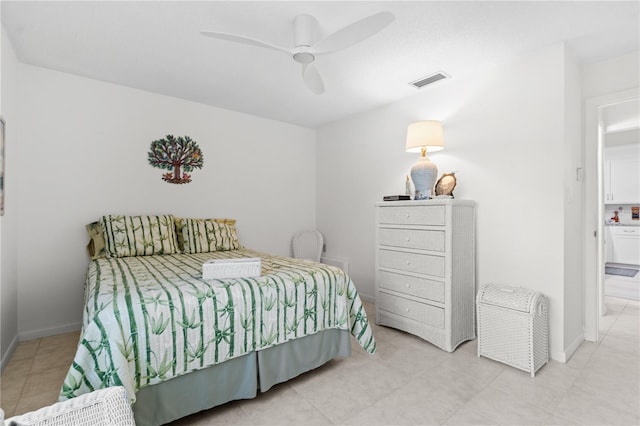 bedroom featuring a ceiling fan, visible vents, baseboards, and ensuite bathroom