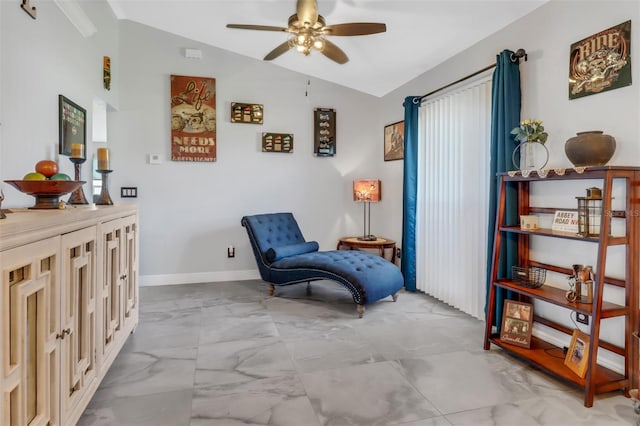 living area with ceiling fan and vaulted ceiling