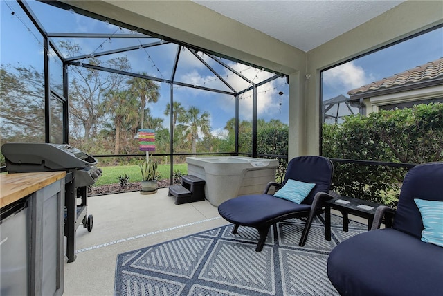 view of patio with grilling area and a lanai