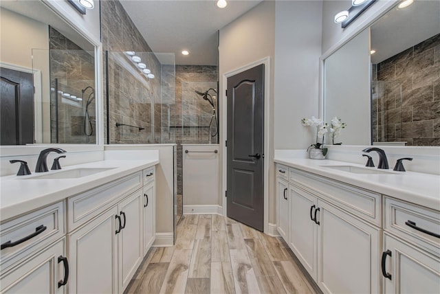 bathroom with vanity and a tile shower