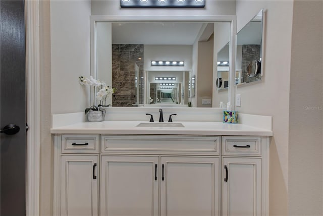 bathroom featuring vanity and tiled shower