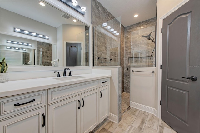 bathroom featuring vanity and a tile shower