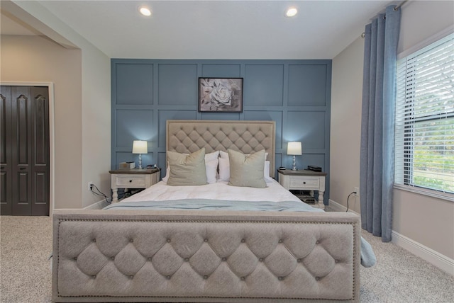 bedroom featuring a closet and light colored carpet