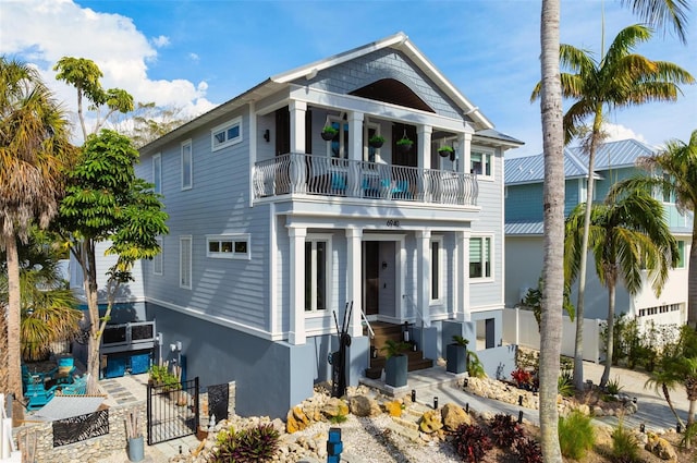 raised beach house featuring a balcony