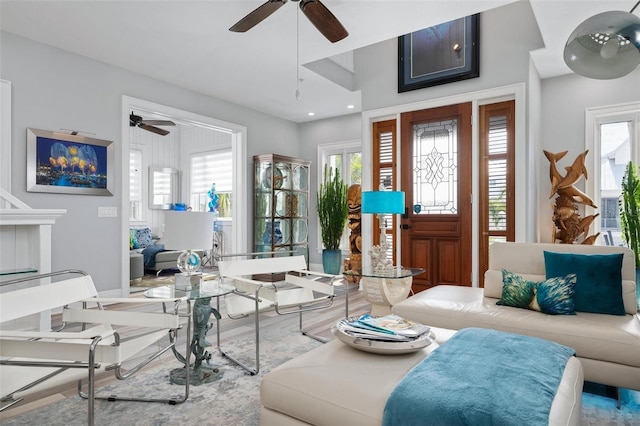 living room featuring hardwood / wood-style floors and ceiling fan