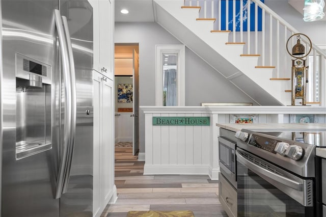 stairway with hardwood / wood-style floors