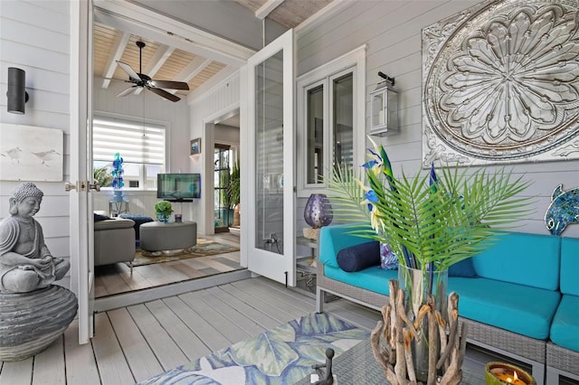 wooden deck with an outdoor hangout area and ceiling fan