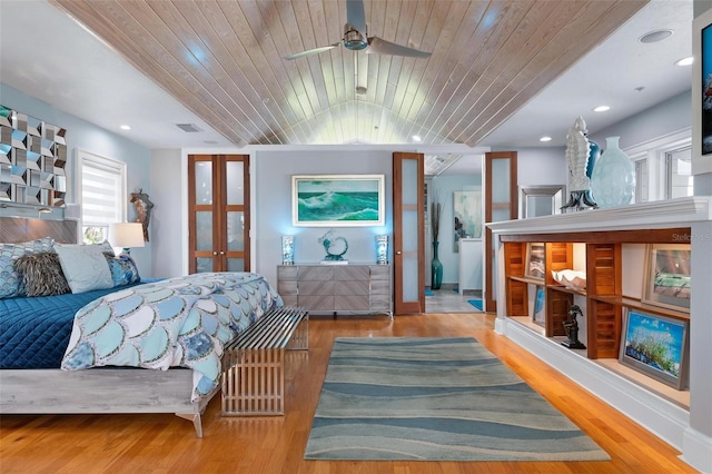 bedroom with french doors, wood ceiling, and light wood-type flooring