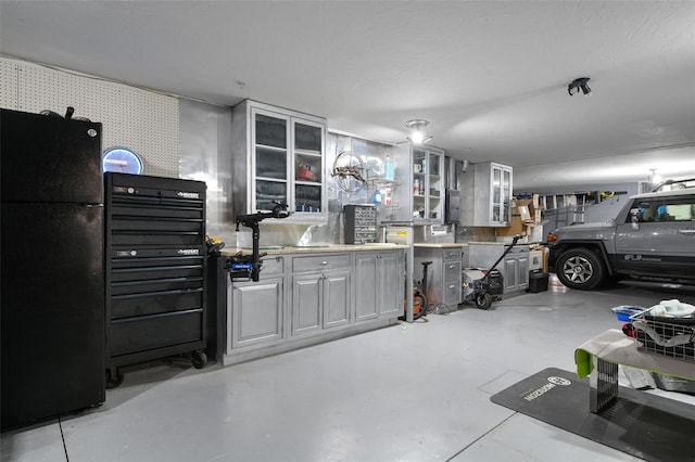 garage featuring black fridge