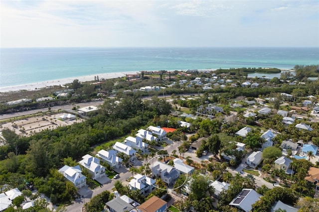 birds eye view of property with a water view and a view of the beach