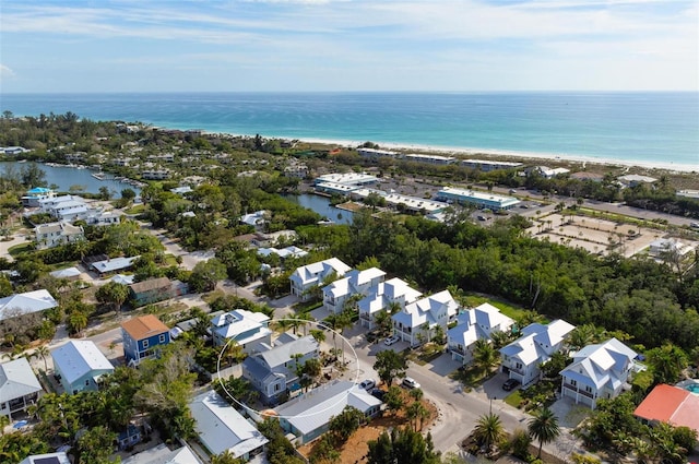 bird's eye view with a water view and a beach view