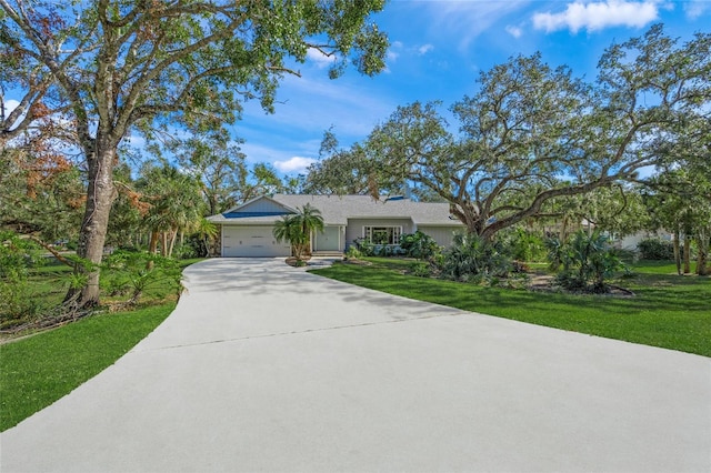 ranch-style home featuring a front yard and a garage