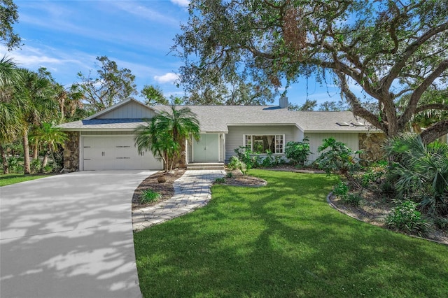 single story home featuring a garage and a front lawn