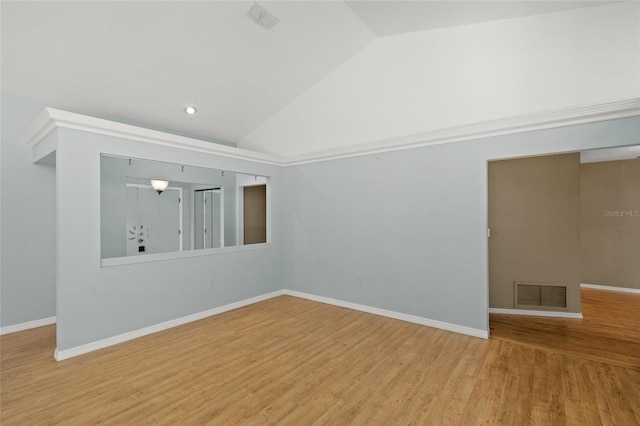 empty room featuring hardwood / wood-style flooring and vaulted ceiling