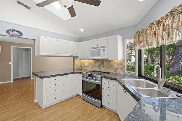 kitchen featuring white cabinetry, lofted ceiling, sink, and electric stove