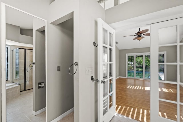 interior space with ceiling fan, french doors, wood-type flooring, and lofted ceiling