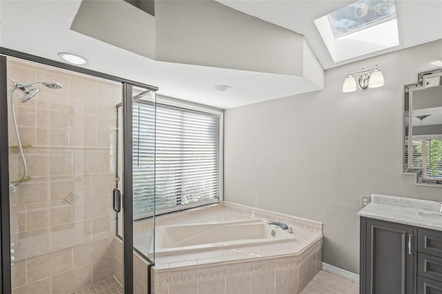 bathroom featuring a skylight, plus walk in shower, tile patterned flooring, and vanity