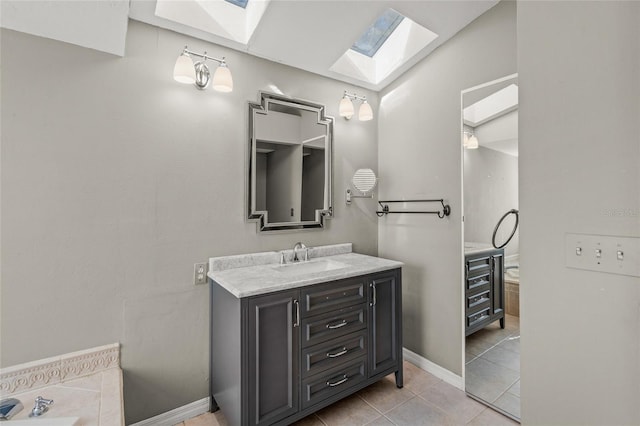 bathroom with tile patterned floors, vanity, and a skylight