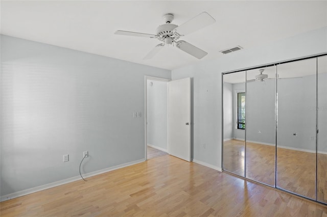 unfurnished bedroom featuring a closet, ceiling fan, and light hardwood / wood-style flooring