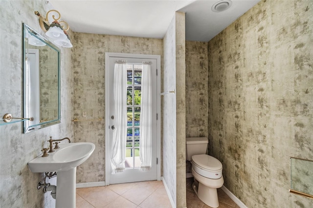 bathroom with tile patterned flooring and toilet