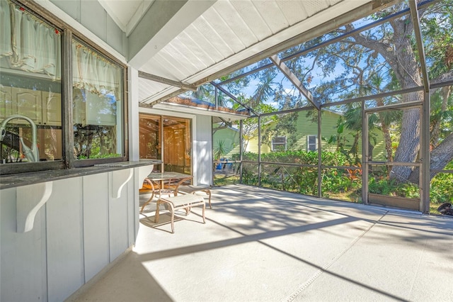 unfurnished sunroom with vaulted ceiling