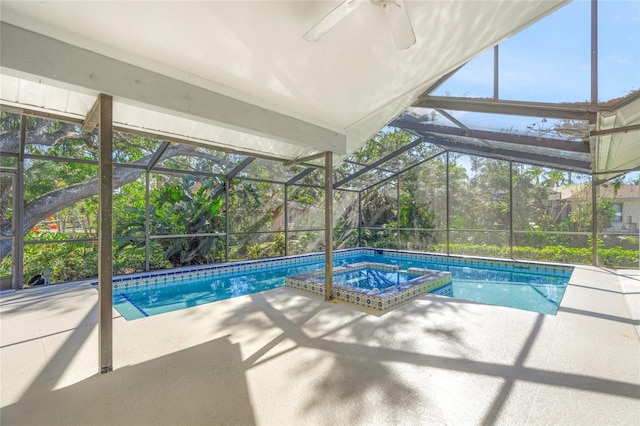 view of swimming pool featuring a lanai, a patio area, and an in ground hot tub