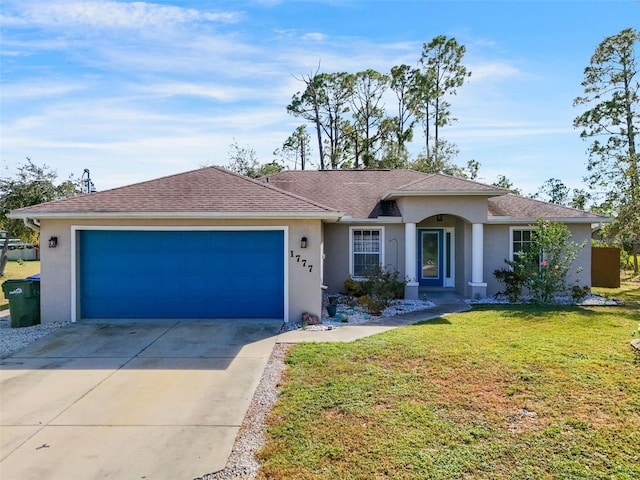 ranch-style house featuring a front lawn and a garage