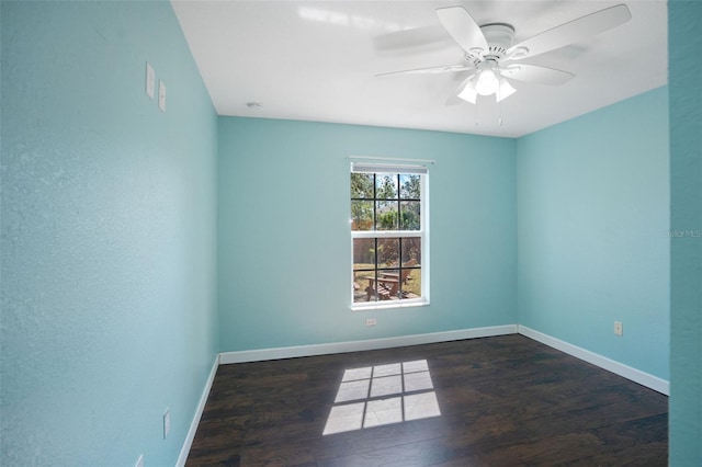 spare room with ceiling fan and dark hardwood / wood-style flooring