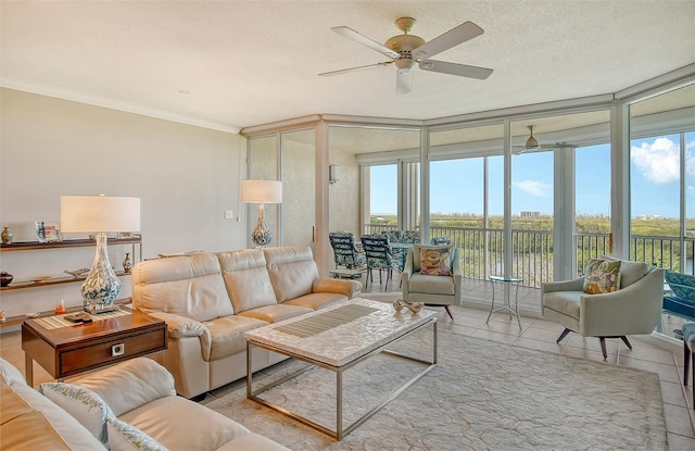 tiled living room with a water view, ornamental molding, ceiling fan, a textured ceiling, and expansive windows