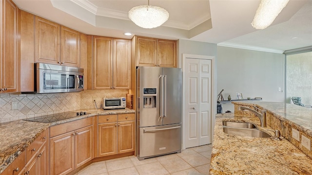 kitchen with stainless steel appliances, sink, pendant lighting, and light stone counters