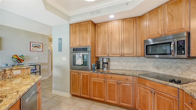 kitchen with appliances with stainless steel finishes, light tile patterned floors, tasteful backsplash, and light stone countertops