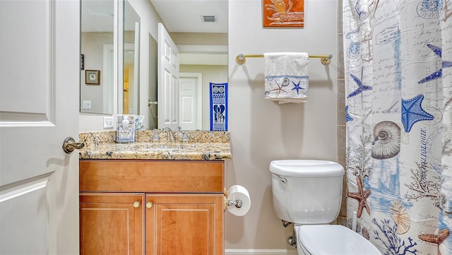 bathroom featuring vanity, toilet, and a shower with shower curtain