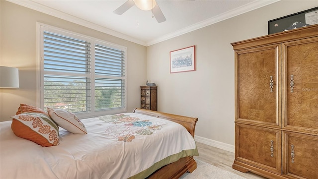 bedroom featuring ornamental molding, light colored carpet, and ceiling fan