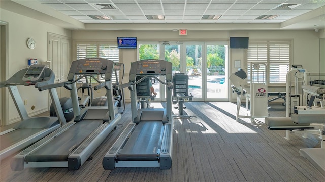 exercise room featuring french doors and a paneled ceiling