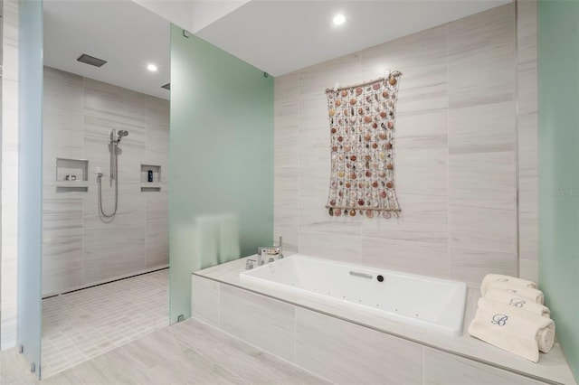 bathroom with independent shower and bath and tile walls